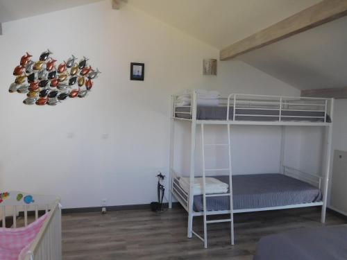 a bedroom with bunk beds with shoes hanging on the wall at Villa Soulacaise V in Soulac-sur-Mer