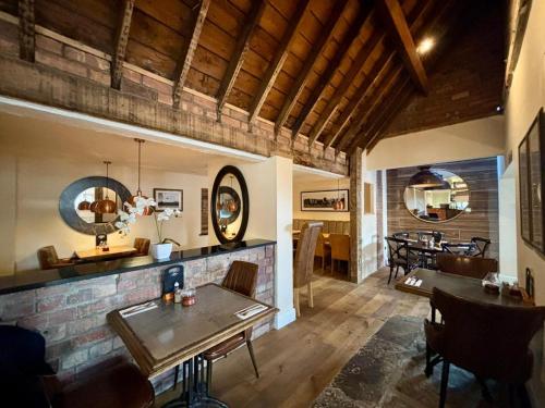 a living room with a table and a dining room at The Horse and Farrier Carlisle in Carlisle
