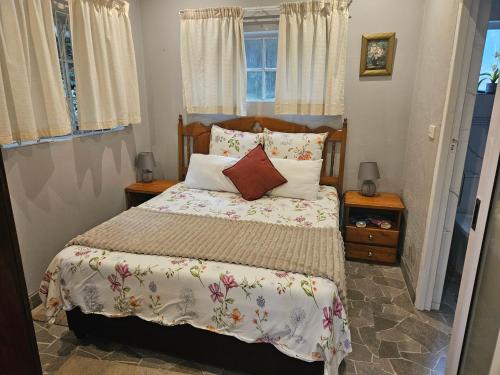 a bedroom with a bed with pillows and a window at Bavarian Getaway in Kloof