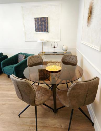 a dining room with a glass table and chairs at Stylish Apartment in Downtown Budapest in Pusztavacs