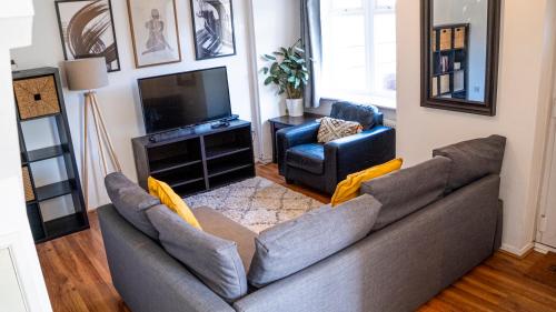a living room with a couch and a television at The Summer House Sleeps 6 , 2 Parking Spaces, Private Garden Walking Distance to Cardiff Bay and City Centre Pets Welcome in Cardiff