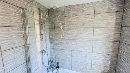 a bathroom with a shower and a toilet at The Summer House Sleeps 6 , 2 Parking Spaces, Private Garden Walking Distance to Cardiff Bay and City Centre Pets Welcome in Cardiff