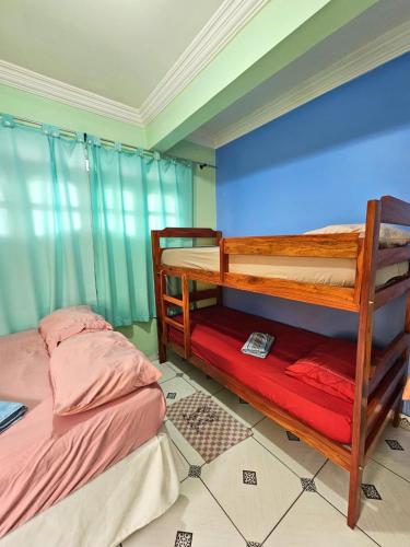 a bedroom with two bunk beds in a room at Hotel Marajoara Breves in Breves
