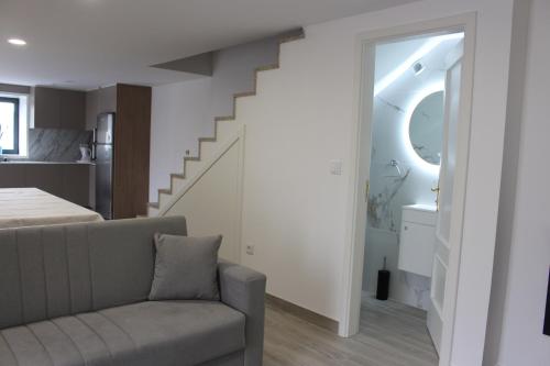 a living room with a couch and a staircase at Recanto da Malhadoira in Currais