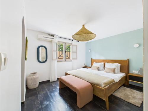 a bedroom with a large bed and a window at Villa Épuré Tribale in Darou Rhamane