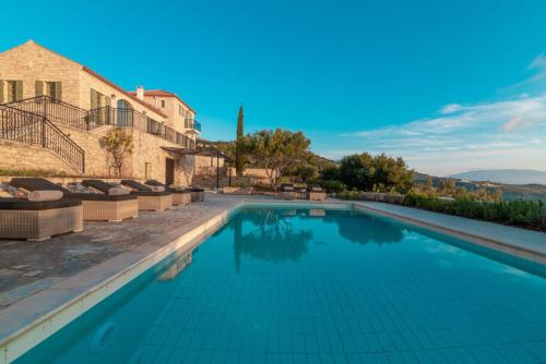 a swimming pool in front of a villa at Villa Athena in Agios Nikolaos