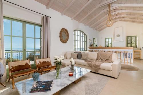 a living room with a couch and a table at Villa Athena in Agios Nikolaos
