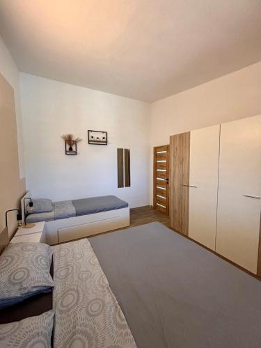 a bedroom with two beds and a closet at Amore in Vir