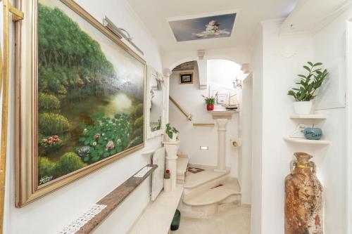 a hallway with a large painting on the wall at Mia Casa Dubrovnik in Dubrovnik
