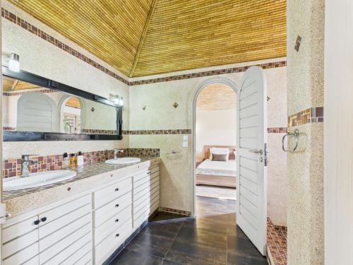 a bathroom with a sink and a mirror at Villa Épuré Tribale in Darou Rhamane