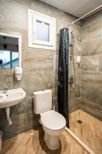 a bathroom with a toilet and a sink and a shower at Къщички Синьо лято, Черноморец - Варна - Blue Summer Houses Varna in Varna City