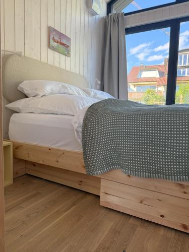 En eller flere senge i et værelse på Tiny7sky