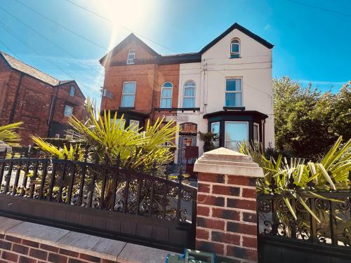 a house with a fence in front of it at Hendham House - Near Etihad Stadium, CoOp Live Arena, AO Arena, Piccadilly Train Station & Manchester City Centre in Manchester