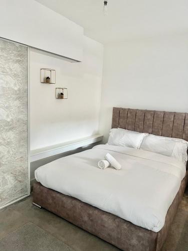 a bedroom with a large bed with white sheets at Digbeth Luxury 1 Bed Studio Apartment in Birmingham