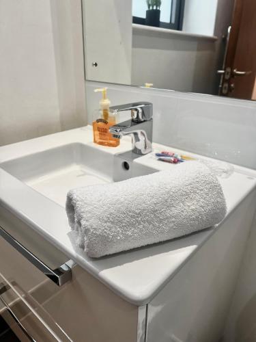a white bathroom sink with a towel on it at Digbeth Luxury 1 Bed Studio Apartment in Birmingham