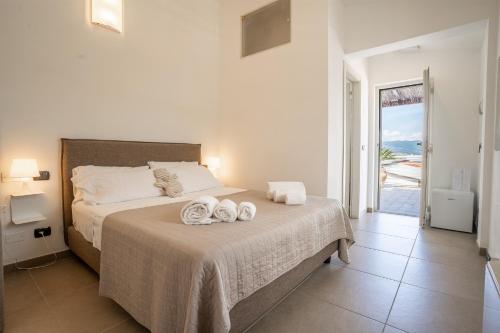 a bedroom with a bed with towels on it at Bagno Lunezia in Marina di Carrara