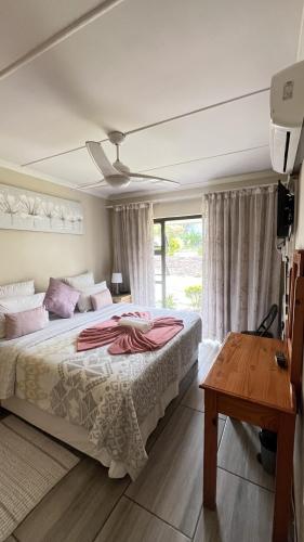 a bedroom with a large bed and a window at Yolonwabo Bed & Beakfast in East London