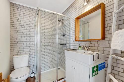 a bathroom with a toilet and a sink and a shower at Casa Do Canto in Cascais