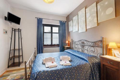 a bedroom with a blue bed with two towels on it at Terraluna in Monforte dʼAlba