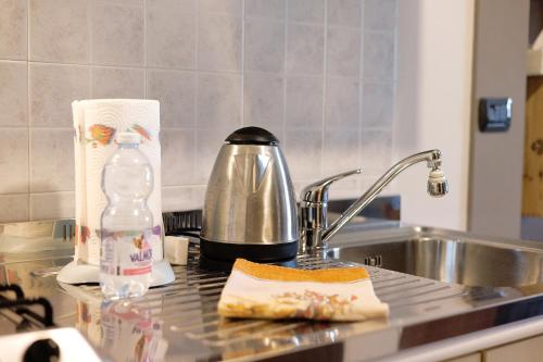 a kitchen counter with a sink and a tea kettle at Terraluna in Monforte dʼAlba