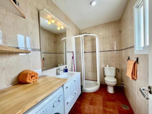 a bathroom with a sink and a toilet at Vera Naked in Vera
