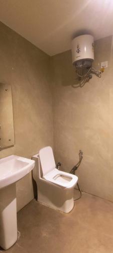 a bathroom with a toilet and a sink at hotel grand vk #Ac family rooms#free wifi#free parking in Agra