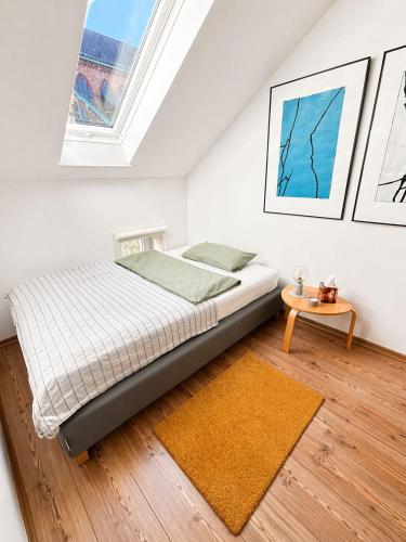 a bedroom with a bed and a table at Ferienwohnung Nikolaiblick in Stralsund