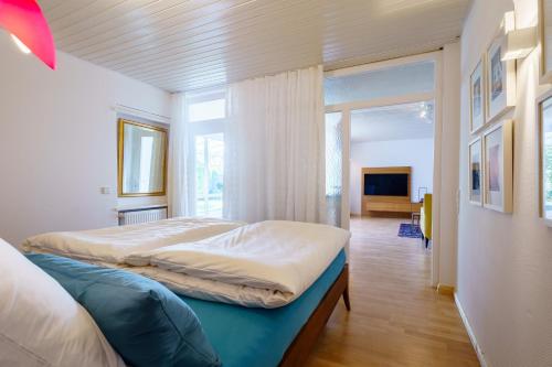 a bedroom with two beds and a large window at Alm-Atelier in Durbach