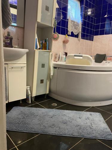 a bathroom with a tub and a sink and a toilet at Privat szobak 3 in Budaörs
