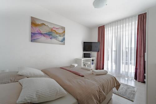 a bedroom with two twin beds and a television at Holiday Villa Pervan in Sesvete