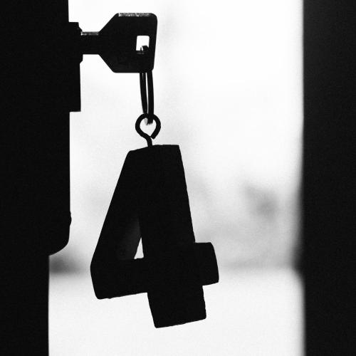 a number four hanging on a chain in front of a door at Mas Ferran Adults Only in Pals
