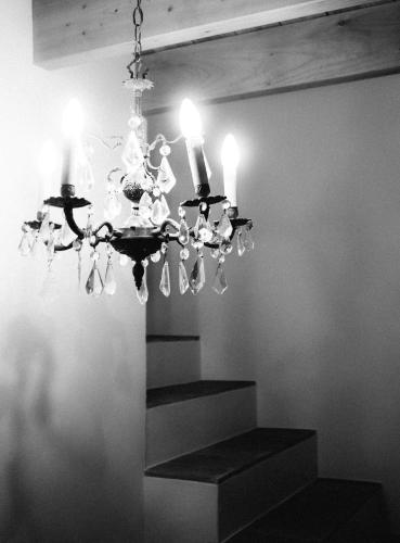 a chandelier with three candles on top of a staircase at Mas Ferran Adults Only in Pals