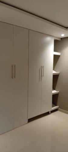 a row of white cabinets in an empty room at Mkhuzewamanzi Accommodation in Mkuze