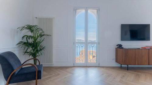 a living room with a window and a tv at LEtoile du Lac in Blevio