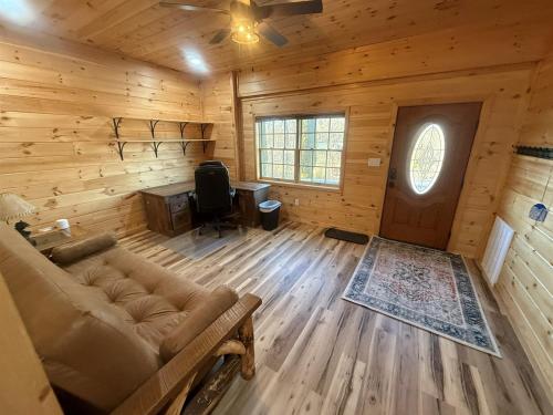 an empty living room with a couch and a window at Small Cabin Over Garage with lake access and small dock in Sevierville