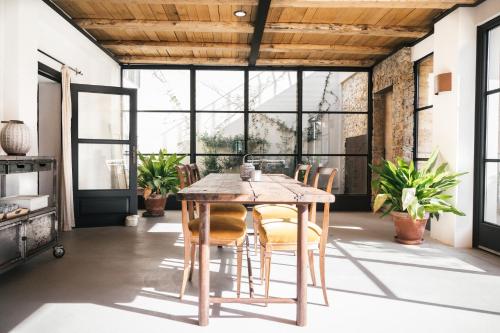 a dining room with a wooden table and chairs at Mas Ferran Adults Only in Pals