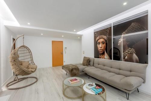 a living room with a couch and a chair at Spacious 3-bedroom condo near Lisbon Airport in Lisbon