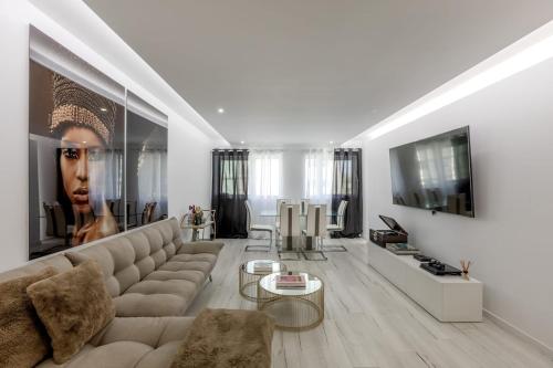 a living room with a couch and a tv at Spacious 3-bedroom condo near Lisbon Airport in Lisbon