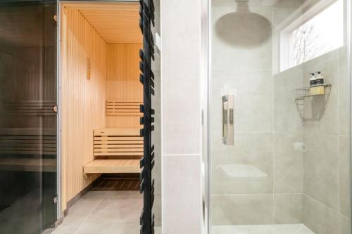 a bathroom with a shower and a glass door at Larch House in Blairgowrie