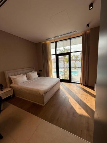 a bedroom with a bed and a large window at Sea Breeze Lighthouse in Nardaran