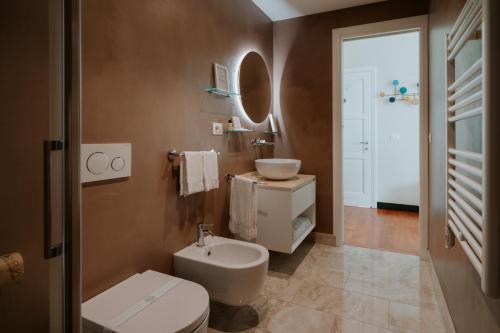 a bathroom with a white toilet and a sink at Locanda da Toto in Genoa
