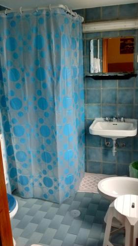 a bathroom with a blue shower curtain and a sink at Hotel San Vincenzo in Soverato Marina