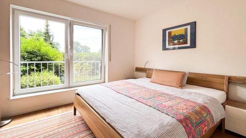 a bedroom with a bed and a large window at "Villa Lorenzo" in Bad Zwischenahn
