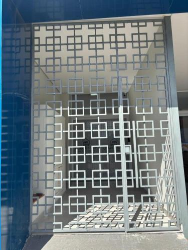 a view of a building from inside a glass door at Quartos Sinop in Sinop