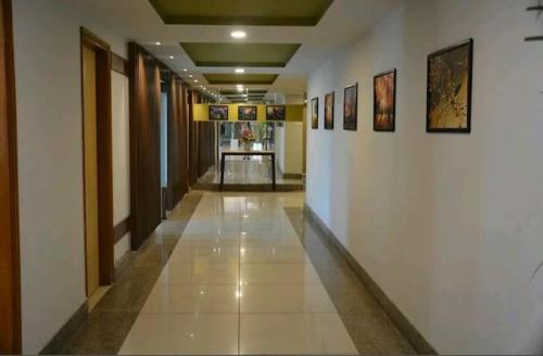 a hallway in a building with paintings on the walls at Saramax INN in Haridwār