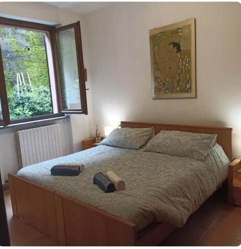 a bedroom with a bed in a room with a window at Casa Lu' in Bosisio Parini