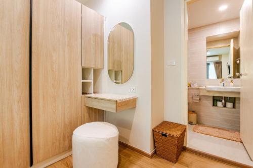 a bathroom with a toilet and a sink and a mirror at Phyll Condominium Luxury 301 2bedroom, Phuket in Ban Rangeng