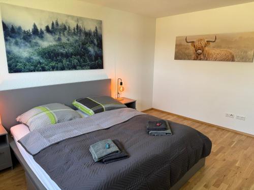 a bedroom with a bed with a picture of a bull on the wall at Lakeview Residence in Schluchsee