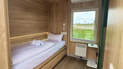 a small bed in a room with a window at Roatel Willich A44 my-roatel-com in Willich