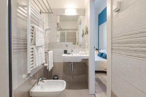 a small bathroom with a sink and a toilet at Rooms Boutique Carducci in Trieste